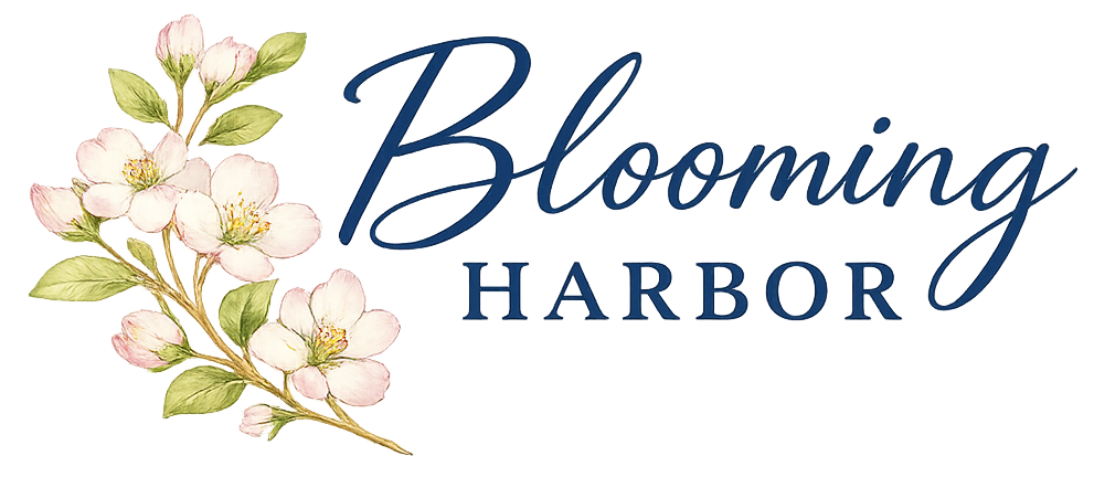 Blooming Harbor logo featuring navy lettering with soft pink apple blossoms on a transparent background.