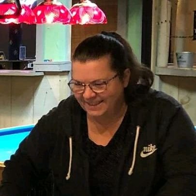 Smiling portrait of Gwennie, founder of Blooming Harbor, welcoming visitors to her website.
